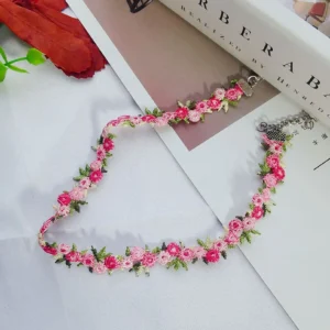 Close-up of sweet flowers embroidered lace choker necklace on a white background