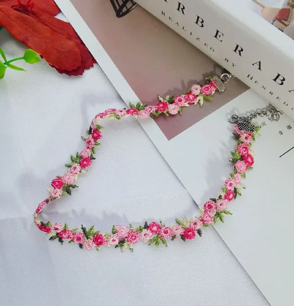 Close-up of sweet flowers embroidered lace choker necklace on a white background