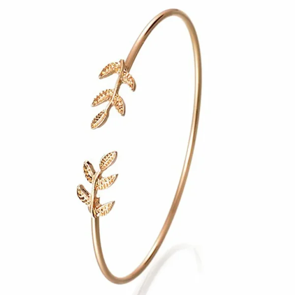 Open cuff bracelet with delicate leaf design on a white background