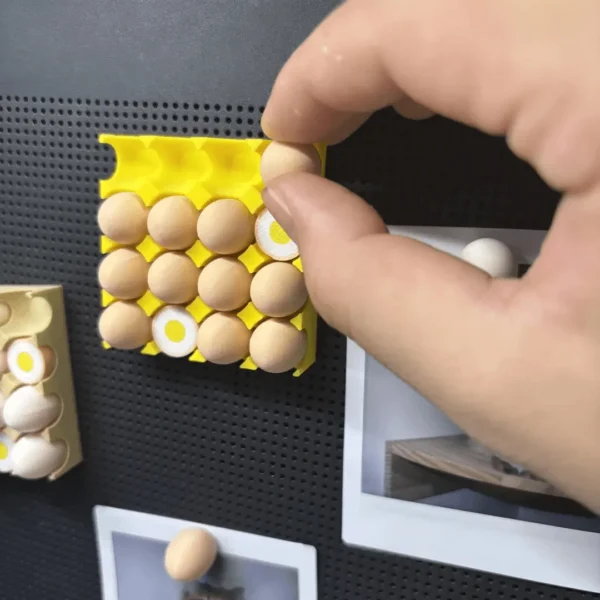 Egg tray shaped magnetic fridge holder with detachable eggs holding photos and notes