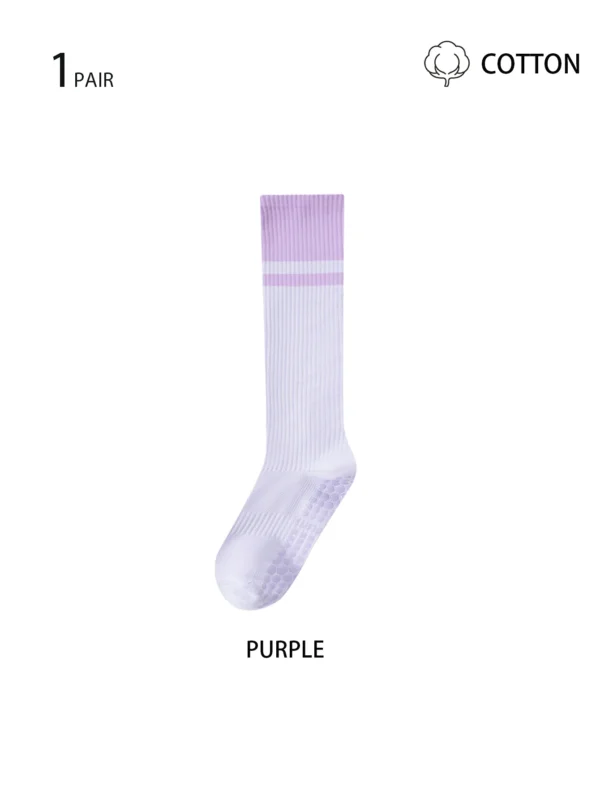 Pair of women's long cotton blend yoga socks with silicone grips on soles