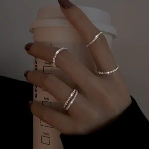Black metal open ring featuring a minimalist heart with drop of oil design