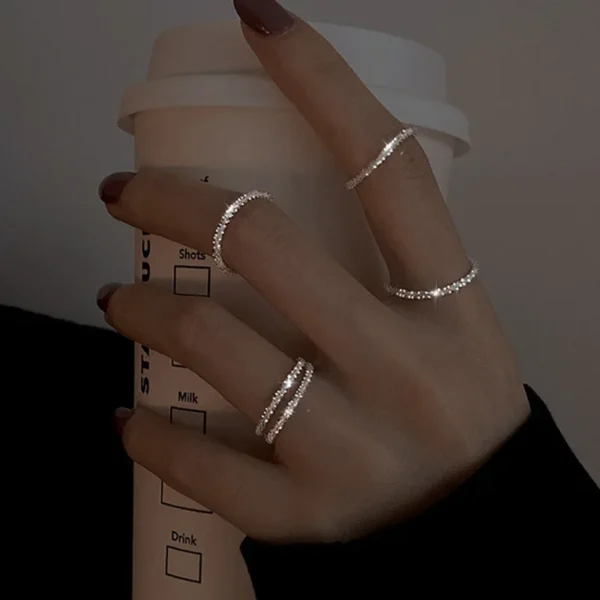 Black metal open ring featuring a minimalist heart with drop of oil design