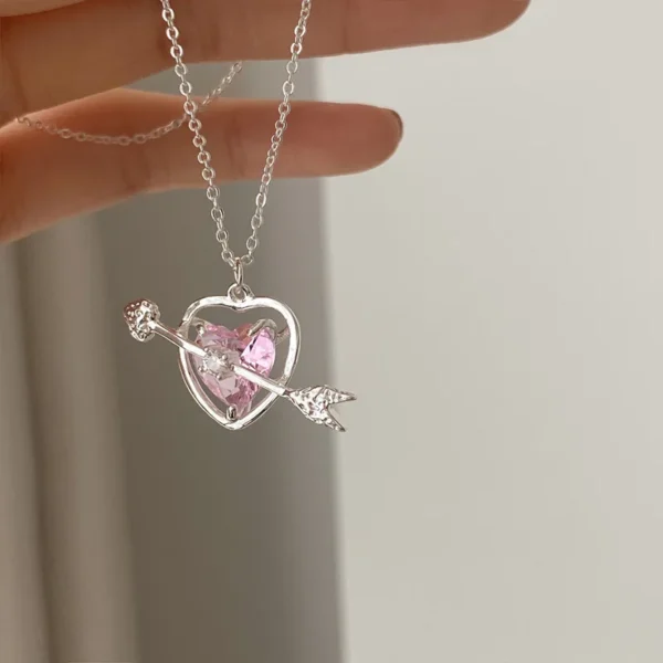 Necklace with pink crystal heart and bow tie pendant on silver-tone chain