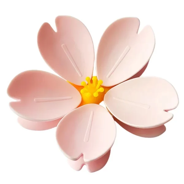 Two Sakura floral petal magnetic clips sealing snack bags on refrigerator