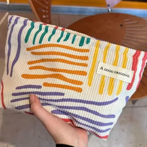 Candy-colored striped corduroy cosmetic bag with contrasting bars