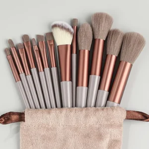 Makeup brush set container with multiple soft wool fiber brushes of various sizes and shapes