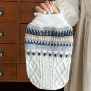 Small to medium dog wearing black and beige vintage style sweater