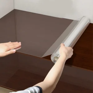 Clear electrostatic protective film rolled out over kitchen wall surface
