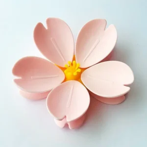 Set of two pink Sakura magnetic snack bag clips with petal design on fridge surface