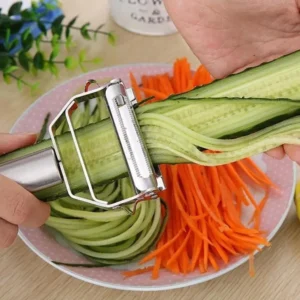 Stainless steel vegetable and fruit peeler with julienne slicer on white background