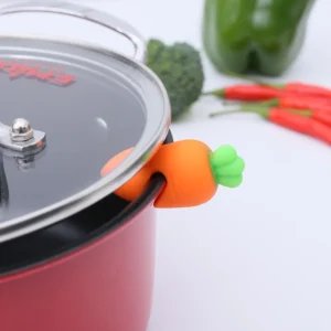 Silicone carrot and chicken leg shaped clips attached to pot lids preventing overflow
