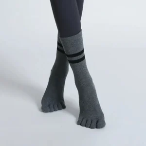 Pair of women’s breathable mid-calf yoga socks with five toe separators and non-slip soles