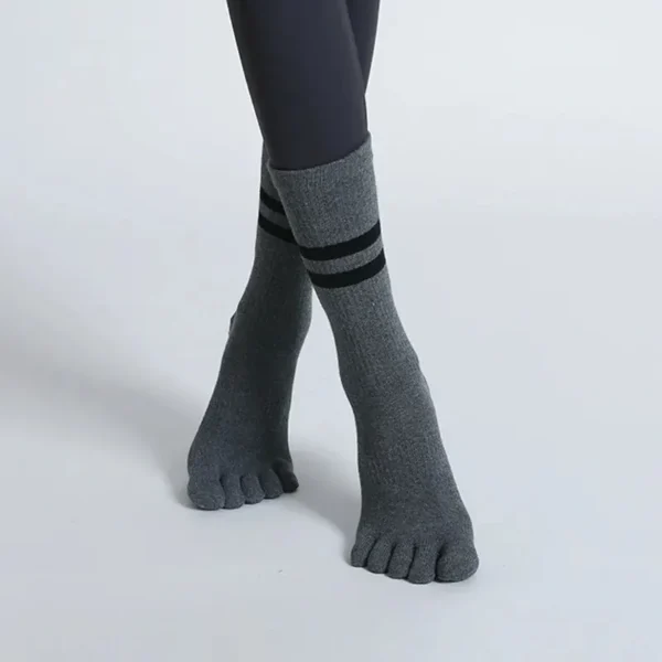 Pair of women’s breathable mid-calf yoga socks with five toe separators and non-slip soles