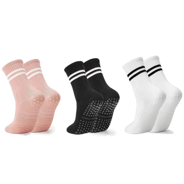 Three pairs of women's long yoga socks with silicone grips laid out