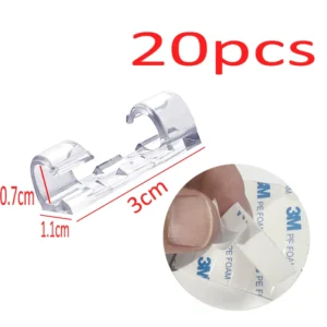 Set of 20 USB cable organizer clips in black, white, and clear with self-adhesive backs on a desk