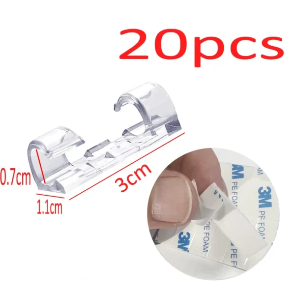 Set of 20 USB cable organizer clips in black, white, and clear with self-adhesive backs on a desk