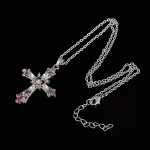 Pink crystal heart cross pendant necklace with silver clavicle chain on white background