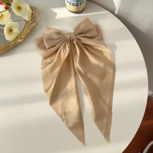 Large satin bow hair clip with spring clamp on white background