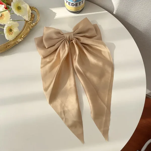 Large satin bow hair clip with spring clamp on white background