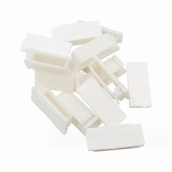 Set of 20 black and white self-adhesive plastic cable clips arranged on a surface