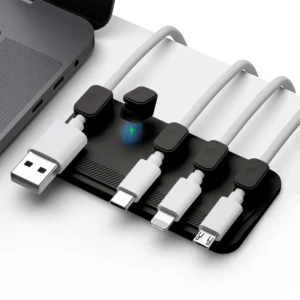 Magnetic plastic cable clip holding a USB charging cable on a desk
