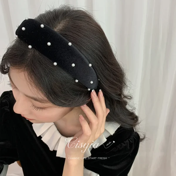Black velvet wide brim headband with pearl decoration on a white background