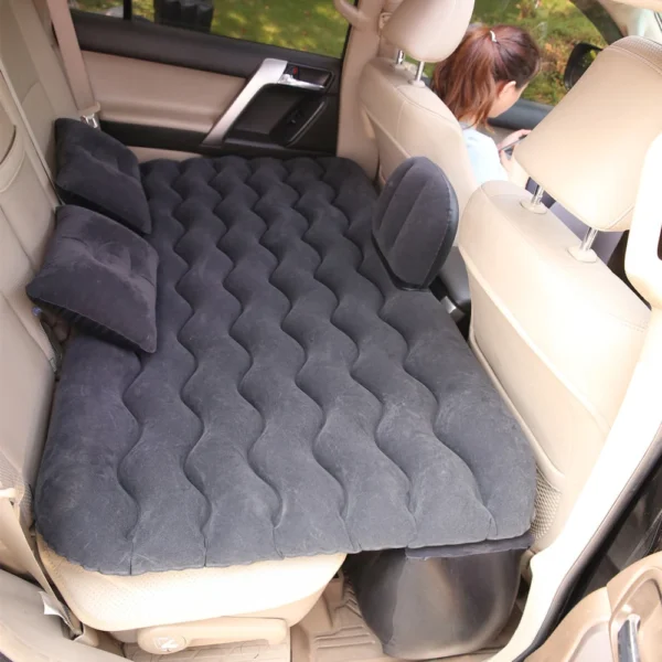 Inflatable travel mattress laid out on car back seat